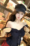 Sex doll wearing a dark outfit and cap in a store setting