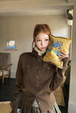 Person holding a bag of chips indoors