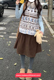 Person wearing a patterned vest and brown skirt on a street, with 'www.nadaoutfitland.com' logo.