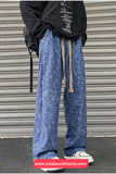 Person wearing blue patterned pants with colorful drawstrings in front of a metallic shutter.