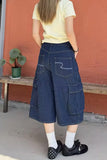 A person shown from the back wearing a pale yellow short-sleeve t-shirt and dark navy wide-leg cargo shorts with white polka dots. The shorts feature contrast white stitching detailing on the pockets.