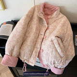 Floral patterned jacket with pink trim on a black surface