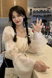 Woman in a white blouse with braided hair in a store setting