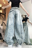 Person wearing light blue acid-wash wide-leg jeans in a store setting.