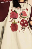 Person wearing a white shirt with cartoon fruit designs and maroon sleeves.