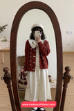 Person taking a mirror selfie wearing a red cardigan and white dress, standing in front of a wooden full-length mirror.