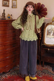 Woman in a vintage-style outfit standing in an ornate room with wooden furniture and decorative items.