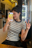 Woman taking a selfie in a cafe, making a peace sign