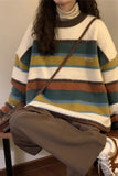 Person wearing a striped sweater with a brown bag, sitting on a chair.