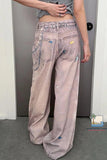 Person wearing light-colored pants with colorful patches in a room.