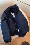 Navy blue jacket on a chair with a wooden floor background