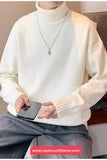 Person wearing a white sweater holding a phone, with a visible brand logo at the bottom.