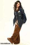 Woman wearing a denim jacket and brown pants on a white background