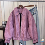 Purple jacket and jeans hanging on a rack against a neutral background