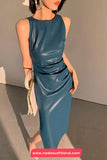 Woman wearing a blue dress with a neutral background