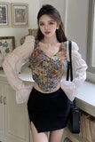 Woman wearing a floral top and black skirt in an indoor setting