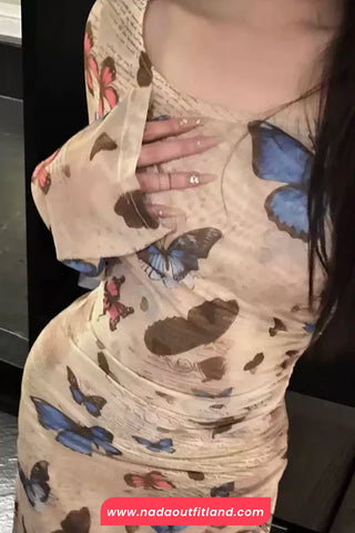 Person wearing a dress with butterfly patterns, brand 'nada outfitland' visible.