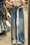 Person wearing blue jeans with a sheer overlay in a store setting