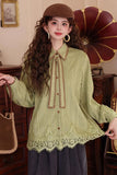 Woman wearing a green lace blouse with a vintage setting
