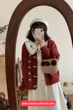 Person taking a mirror selfie wearing a red cardigan and white dress with a floral headband.