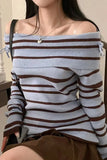 Person wearing a blue and brown striped off-shoulder sweater.