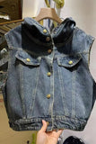 Denim vest on a hanger with a hand holding it
