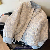 Floral patterned jacket on a chair with a visible brand name.