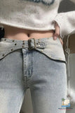Close-up of light blue jeans with a belt, worn by a person.