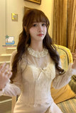Woman wearing a white lace blouse in an indoor setting