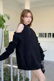 Woman wearing a black sweater on a balcony
