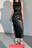 Woman wearing a black leather dress against a gray background