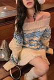 Person wearing a white and blue patterned sweater with a skirt, sitting indoors.