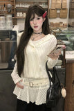 Woman in a white outfit holding a phone in a store setting