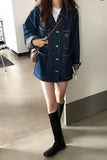 Person wearing a denim jacket and black knee-high boots indoors.
