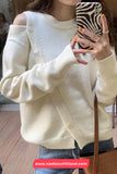 Person wearing a cream-colored sweater holding a phone with a zebra print case.