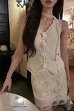 Woman wearing a white lace dress in an indoor setting