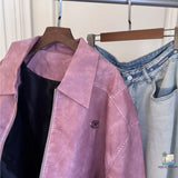 Pink jacket and jeans on a rack with a white curtain background