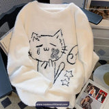 White fluffy sweater with a black cat design on a magazine
