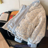 Floral-patterned jacket on a chair with books underneath