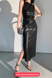 Woman wearing a black leather dress against a plain background with 'nadaoutfitland.com' branding.