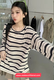 Woman wearing a striped dress in a clothing store